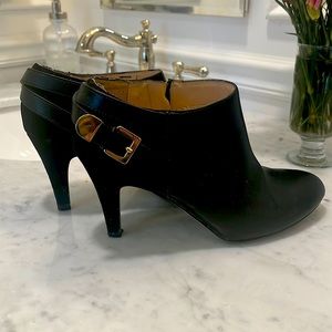 Black booties with a gold strap and buckle- small knick on toe as pictured.